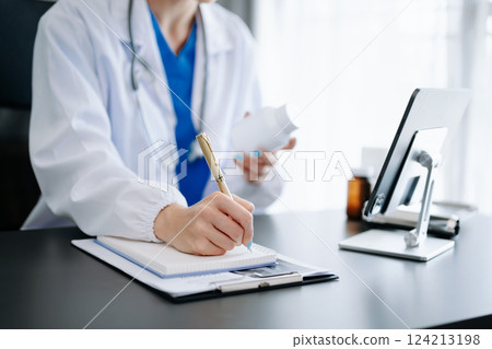 Medical technology concept. Doctor working with mobile phone and stethoscope in office 124213198