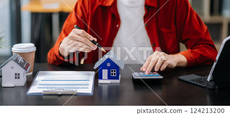 Signing a contract. Client and broker agent, lease agreement, successful deal and Young business sitting Signing a contract. Client and broker agent, lease agreement, successful deal and Young business sitting 124213200
