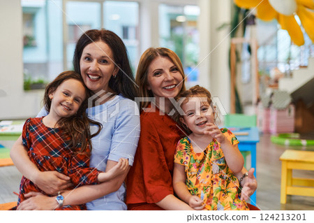 A child hugging a teacher in a modern kindergarten A child hugging a teacher in a modern kindergarten 124213201