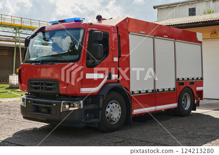 A state-of-the-art firetruck, equipped with advanced rescue technology, stands ready with its skilled firefighting team, prepared to intervene and respond rapidly to emergencies, ensuring the safety A state-of-the-art firetruck, equipped with advanced rescue technology, stands ready with its skilled firefighting team, prepared to intervene and respond rapidly to emergencies, ensuring the safety 124213280