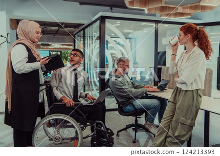 Young group of business people brainstorming together in a startup space, discussing business projects, investments, and solving challenges. 124213393