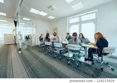 Diverse Business Team Discussing Projects in a Modern Glass Office. 124213429