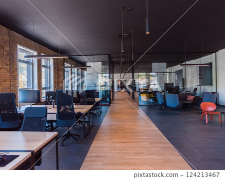 In a setting of modern, glass-walled business startup offices, the open, airy workspace reflects a contemporary and innovative ambiance, promising a dynamic environment for entrepreneurial growth 124213467
