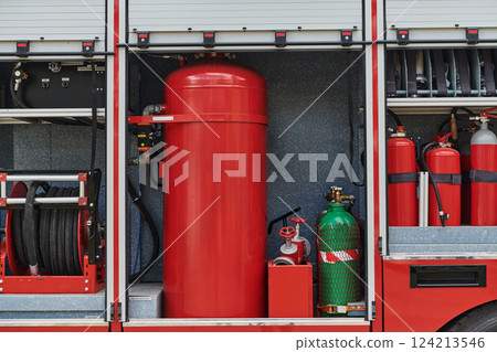 Close-up of essential firefighting equipment on a modern firetruck, showcasing tools and gear ready for emergency response to hazardous fire situations Close-up of essential firefighting equipment on a modern firetruck, showcasing tools and gear ready for emergency response to hazardous fire situations 124213546