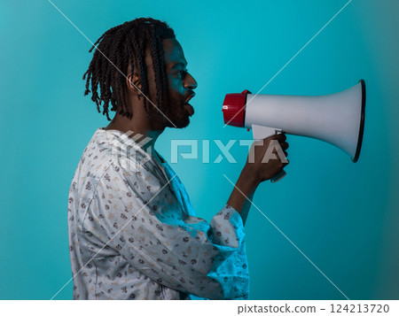African American man dons traditional attire, passionately utilizing a megaphone against a striking blue background, symbolizing his vocal and cultural empowerment in the pursuit of social justice and African American man dons traditional attire, passionately utilizing a megaphone against a striking blue background, symbolizing his vocal and cultural empowerment in the pursuit of social justice and 124213720