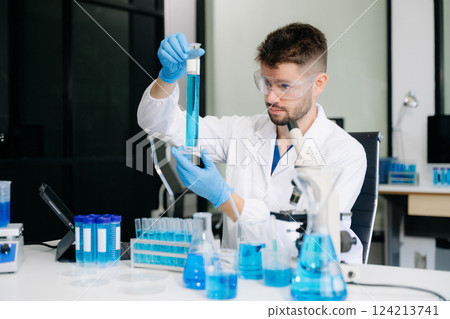 male scientist working with micro pipettes analyzing biochemical samples, advanced science male scientist working with micro pipettes analyzing biochemical samples, advanced science 124213741