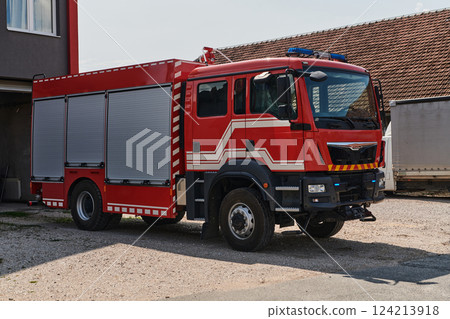A state-of-the-art firetruck, equipped with advanced rescue technology, stands ready with its skilled firefighting team, prepared to intervene and respond rapidly to emergencies, ensuring the safety 124213918