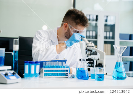 Male biotechnologist testing new chemical substances in a laboratory. 124213942