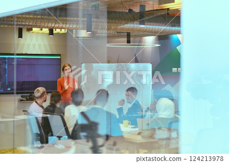 A pregnant business woman with orange hair confidently presents her business plan to colleagues in a modern glass office, embodying entrepreneurship and innovation A pregnant business woman with orange hair confidently presents her business plan to colleagues in a modern glass office, embodying entrepreneurship and innovation 124213978