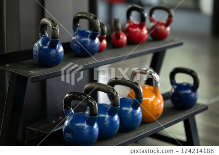 A pair of dumbbells neatly arranged in the gym, ready for a powerful workout session to build strength and endurance A pair of dumbbells neatly arranged in the gym, ready for a powerful workout session to build strength and endurance 124214188
