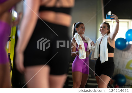 Two fitness women posing for a photoshoot after an intense workout, capturing their strength, determination, and fitness journey. Two fitness women posing for a photoshoot after an intense workout, capturing their strength, determination, and fitness journey. 124214651