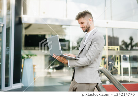 Modern businessman outdoors, using a tablet. Ideal for business, technology, and innovation themes. Modern businessman outdoors, using a tablet. Ideal for business, technology, and innovation themes. 124214770
