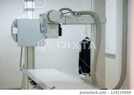 Modern X-ray machine in a medical examination room. 124214899