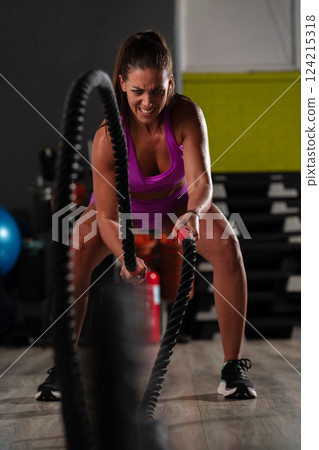 Fit Woman Performing Rope Conditioning Exercise in the Gym Fit Woman Performing Rope Conditioning Exercise in the Gym 124215318