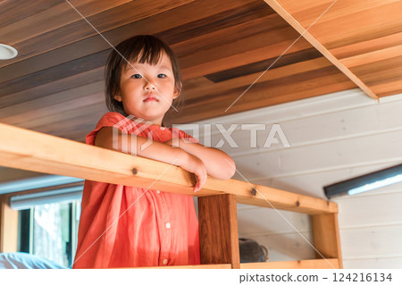 Girl playing in the loft/attic of a cottage 124216134