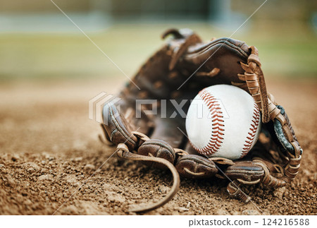 Baseball, leather glove and ball on pitch sand after fitness, workout or training for match or competition. Zoom, texture and softball mitt on field for sports team, wellness exercise or stadium game Baseball, leather glove and ball on pitch sand after fitness, workout or training for match or competition. Zoom, texture and softball mitt on field for sports team, wellness exercise or stadium game 124216588