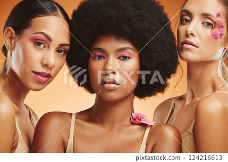 Diversity, beauty and women with flowers for makeup, skincare and cosmetics. Skincare products, spa wellness and group of girls portrait in orange studio with pink orchids for natural beauty products Diversity, beauty and women with flowers for makeup, skincare and cosmetics. Skincare products, spa wellness and group of girls portrait in orange studio with pink orchids for natural beauty products 124216613