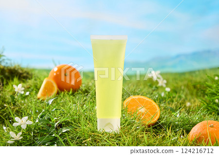 Lush green grass garden with eye-catching cut oranges. Light yellow tube unbranded, used for design. Green grass with tiny flowers. Blue sky background creates sense of majestic natural scenery. Lush green grass garden with eye-catching cut oranges. Light yellow tube unbranded, used for design. Green grass with tiny flowers. Blue sky background creates sense of majestic natural scenery. 124216712