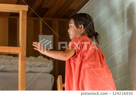 Girl playing in the loft/attic of a cottage Girl playing in the loft/attic of a cottage 124216830
