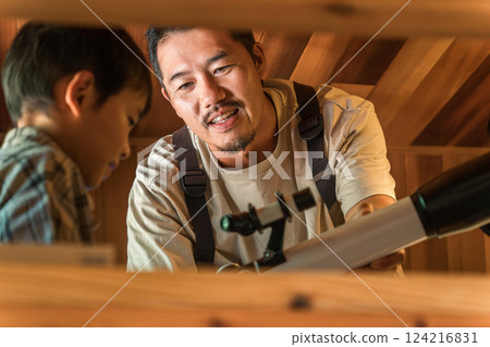 Child and dad playing with a telescope during summer vacation (cottage, villa, mountain hut, camping, glamping) Child and dad playing with a telescope during summer vacation (cottage, villa, mountain hut, camping, glamping) 124216831