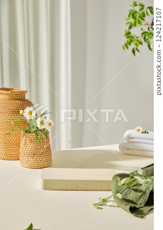 White wooden tray in the center, with empty space to display products and designs. Green canvas with leaves placed on top. Rattan flower vases placed around for decoration. Minimalist concept. White wooden tray in the center, with empty space to display products and designs. Green canvas with leaves placed on top. Rattan flower vases placed around for decoration. Minimalist concept. 124217107