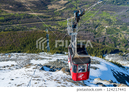 Jasper, Alberta, Canada - May 21 2021 : Jasper SkyTram aerial tramway ascending the snow-capped Rocky Mountains. 124217441