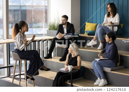 African woman leads corporate meeting with colleagues 124217618