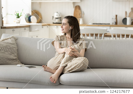 Relaxed beautiful young woman listen to soothing music in earbuds 124217677