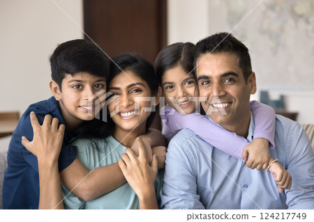 Portrait of parents and their two children posing for camera Portrait of parents and their two children posing for camera 124217749
