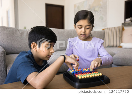 Two Indian kids engaged in educational game at home 124217750