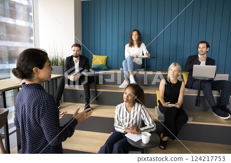 Pretty Indian presenter make speech stand in front of audience Pretty Indian presenter make speech stand in front of audience 124217753