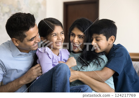 Beautiful carefree Indian parents play with two adorable kids Beautiful carefree Indian parents play with two adorable kids 124217769