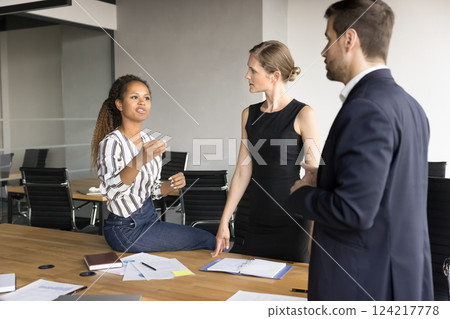Three colleagues professionals engaged in discussion related to work matters Three colleagues professionals engaged in discussion related to work matters 124217778