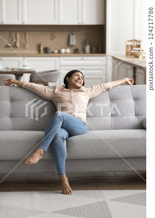 Millennial female relax on comfortable sofa at cozy domestic interior 124217786