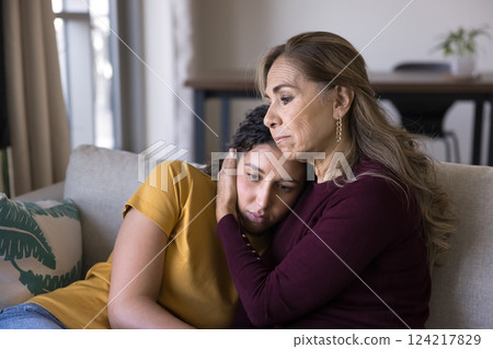 Loving mother hugging, comforting her adult daughter Loving mother hugging, comforting her adult daughter 124217829