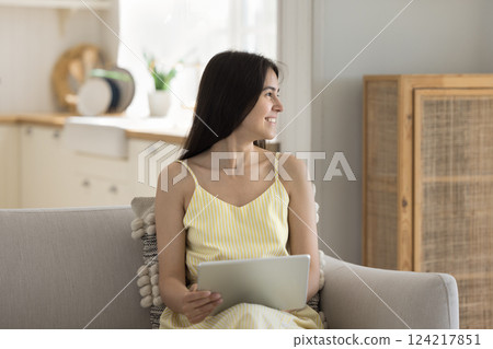Happy gen z girl relax on sofa dream hold tablet Happy gen z girl relax on sofa dream hold tablet 124217851