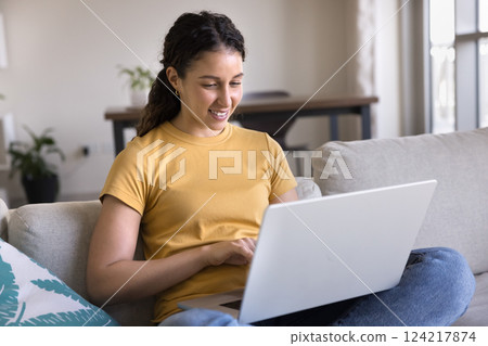 Latin woman spend weekend time on internet using laptop Latin woman spend weekend time on internet using laptop 124217874