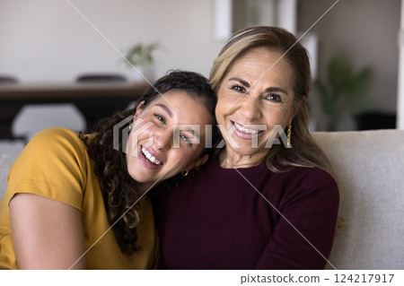 Young adult daughter posing for camera with older mother Young adult daughter posing for camera with older mother 124217917