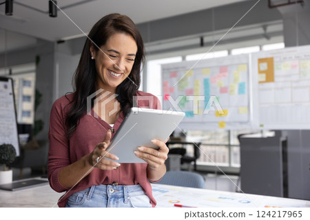 Happy successful business project leader woman using online application Happy successful business project leader woman using online application 124217965