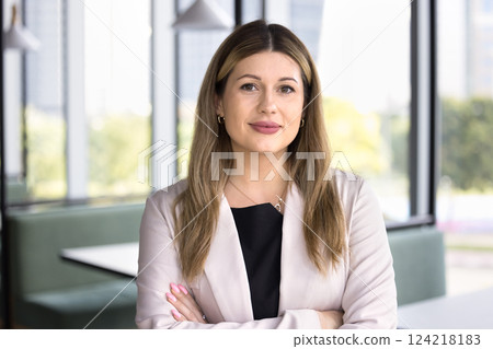 Smiling attractive business woman looking at camera Smiling attractive business woman looking at camera 124218183