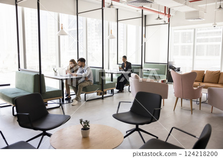 People working in modern, open-space co-working area 124218200