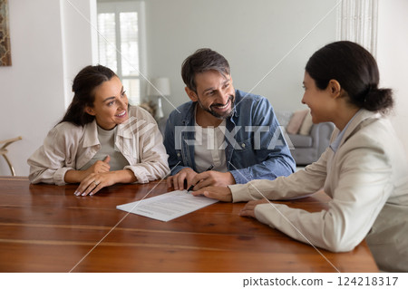 Happy husband and wife meeting with realtor, financial broker Happy husband and wife meeting with realtor, financial broker 124218317