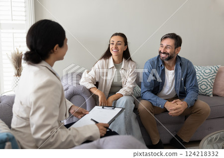 Happy couple of homeowners meeting with insurance agent at home Happy couple of homeowners meeting with insurance agent at home 124218332