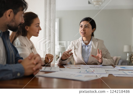 Indian financial broker woman and Caucasian couple discussing investment 124218486