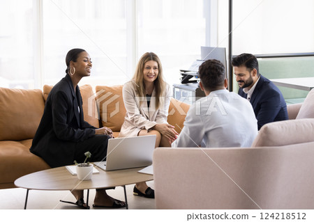 Four multiethnic staff members met in office lobby during break Four multiethnic staff members met in office lobby during break 124218512