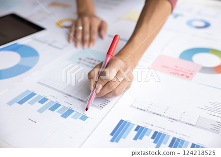 Cropped unrecognizable shot of young businesswoman analyzing sales Cropped unrecognizable shot of young businesswoman analyzing sales 124218525
