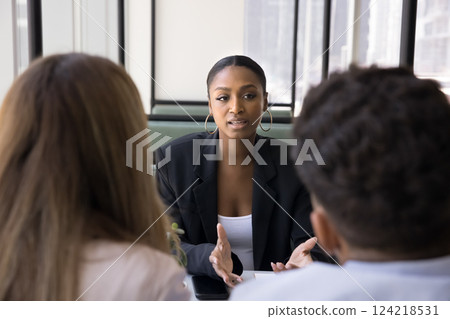 Advisor consulting young married couple met in bank office 124218531