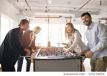 Four multiethnic colleagues playing together table football 124218620