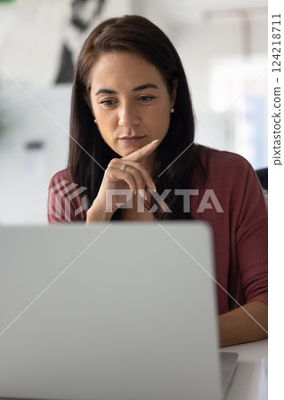 Focused pensive business woman working at laptop Focused pensive business woman working at laptop 124218711