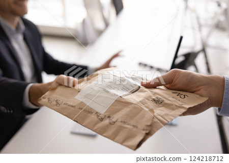 Business man taking logistic delivery package from office assistant, courier Business man taking logistic delivery package from office assistant, courier 124218712